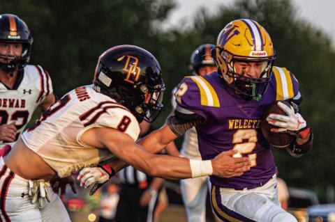 Junior Kellen Sheneman breaks a tackle to move the chains for the Outlaws.