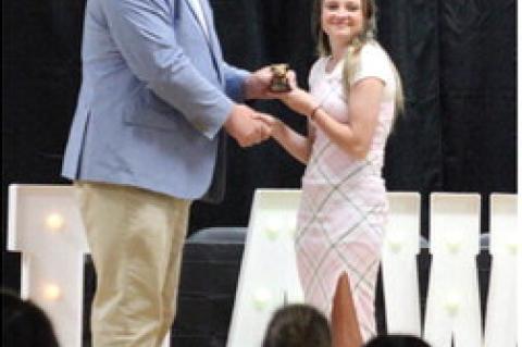 Kayla Bain receives the Girls' Basketball Bulldog Award Trophy presented by Superintendent Jared Winningham