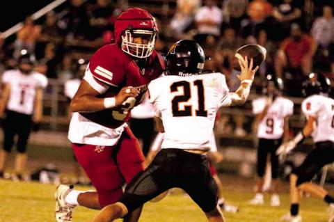 Phillip Ross closes in on the Longhorn quarterback. Photos by Dane Smart, Tribune Sports Reporter