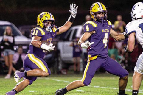 Noah Hare with the carry gets strong block from his brother Eli