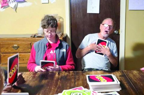Amy and Danny strategizing over UNO!